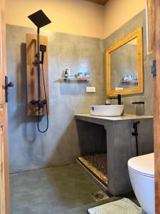 a bathroom with a sink and a mirror at Whispering Wave Tangalle in Tangalle
