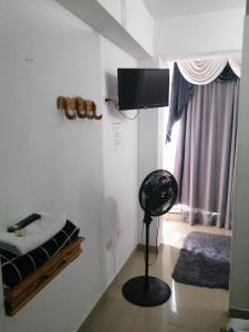 a room with a bedroom with a bed and a fan at The Best Corner in San Rafael +73 photos