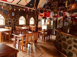 a restaurant with wooden tables and chairs in a room at Penguin Hostel in Puerto Ayora +15 photos