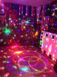 a room with colorful lights on the dance floor at Penguin Hostel in Puerto Ayora