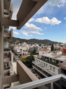 a view of the city from the balcony of a building at City Paz in Villa Carlos Paz