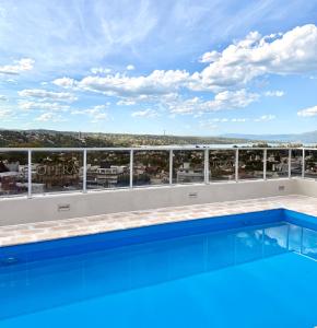 a swimming pool on the roof of a building at City Paz in Villa Carlos Paz