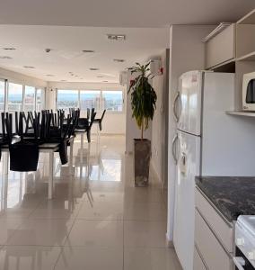 a kitchen with a table and chairs and a refrigerator at City Paz in Villa Carlos Paz