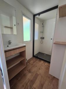 a bathroom with a sink and a mirror at Camping 3 étoiles - Piscine - eeicbi in Le Change