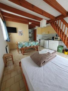 a bedroom with a large white bed in a room at Camping 3 étoiles - Piscine - eeicbi in Le Change