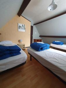 two beds in a room with blue pillows on them at Camping 3 étoiles - Piscine - eeicbi in Le Change