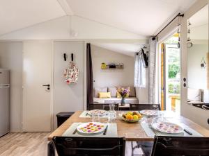 a kitchen with a table with fruits on it at Mobil-home à Pordic 4 pers. avec Terrasse - API-1-52-1204 in Pordic