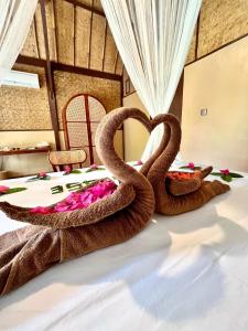 two snakes sitting on top of a bed at Gila House - Adults only in Gili Islands +21 photos