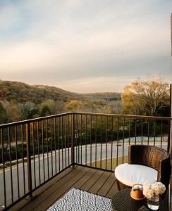 a balcony with a chair and a table with a view at Luxury Mountain Views at Prime Location Huntsville in Huntsville