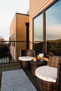 a patio with wicker chairs and a table on a balcony at Luxury Mountain Views at Prime Location Huntsville in Huntsville +16 photos