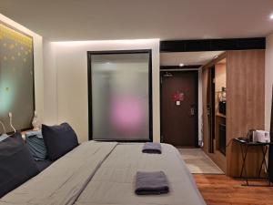 a large bed in a room with a sliding glass door at 4 Floor - Pool view Studio room at TBHR near Kata beach in Kata Beach