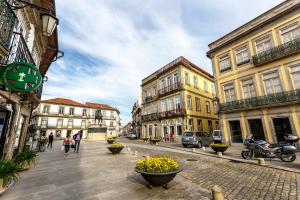 a city street with buildings and people walking on the street at Bright Luxury Apartment in Viana do Castelo +13 photos