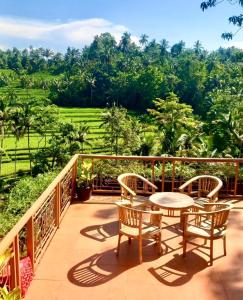 a balcony with a table and chairs and a view at Whispering Hills in Perean