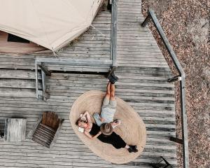 a woman is laying on a circle on a wooden floor at Kookaburra Ridge in Wyee