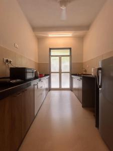 a large kitchen with a door to a door at Marvella Stays in Anjuna