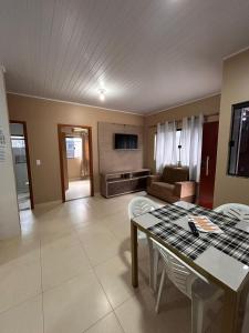 a kitchen and living room with a table and chairs at Residencial Roma in Palmas