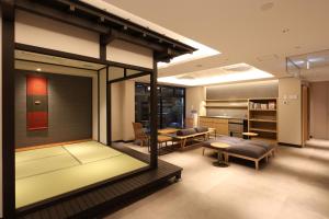 a living room with a table and chairs and a room at HATAGO HIKONE - Annex in Hikone