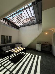 a living room with a large skylight and a table at The Marseille Oasis in La Porteña