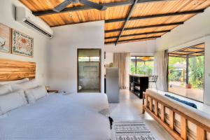a bedroom with a large bed and a fireplace at Salt n Pepper - Rosemary Villa with shared Pool - Adults Only in Puerto Viejo +50 photos