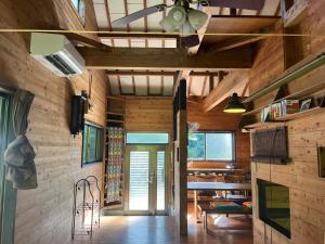 a living room with wooden walls and a ceiling at ペシュール ヤクシマ in Funayuki