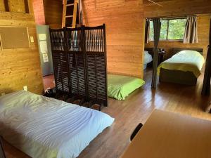 Ένα ή περισσότερα κρεβάτια σε δωμάτιο στο ペシュール ヤクシマ