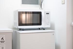 a microwave sitting on top of a refrigerator at NAGI setouchi in Takamatsu