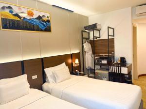 a hotel room with two beds in a room at A25 Premium Hotel - 12 Ngô Sỹ Liên in Hanoi +36 photos