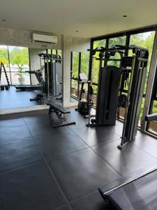 a gym with several tread machines in a room at Elegant 3 bedroom Villa in Jimbaran