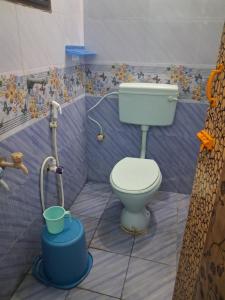 a bathroom with a toilet and a shower at Bhavadesh Lodge in Virudunagar