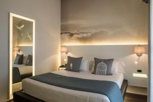 En eller flere senge i et værelse på Ariae Dépendance - Alihotels