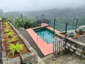 a swimming pool with a view of a mountain at Thazhvaram Pool Villa Idukki Calvary Mount in Idukki