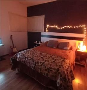 a bedroom with a bed with lights on it at Cabañas Ojos de Cielo in Santa Rosa de Calamuchita +70 photos