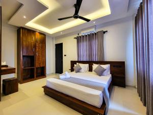 a bedroom with a bed and a ceiling fan at Lavinia Beach Hotel Ambalangoda in Ambalangoda