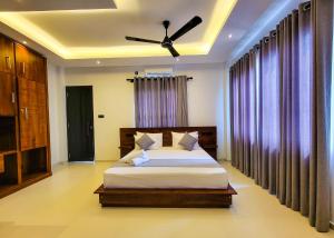 a bedroom with a bed and a ceiling fan at Lavinia Beach Hotel Ambalangoda in Ambalangoda