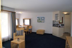 a hotel room with a kitchen and a living room at Ferienwohnungen Hotel Allegra in Zuoz +31 photos