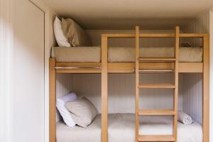 a bunk bed room with two bunk beds in it at Tiny Oscar in Robertson