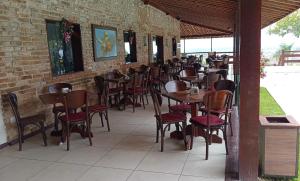 a row of tables and chairs at a restaurant at Flat Paz & Relax Monte Castelo 1809 in Sairé
