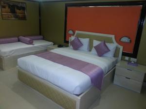 Ένα ή περισσότερα κρεβάτια σε δωμάτιο στο Bowshar International Hotel