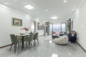 a living room with a table and chairs at Skyline Riverview Apartments in Chongqing