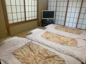 Ένα ή περισσότερα κρεβάτια σε δωμάτιο στο Cottage Karuizawa