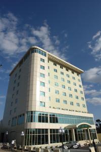a large white building with a lot of windows at Dreamliner Hotel in Addis Ababa