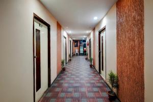 a hallway of a building with a long corridor at Collection O Lokmanya Nagar Metro Station Formerly Hotel Siddhivinayak in Rāipur