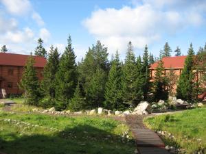 a wooden path in front of a building at Solovki Hotel in Solovetsky Islands