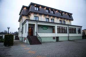 a building with a staircase in front of it at Hotel Bukowiec in Legionowo