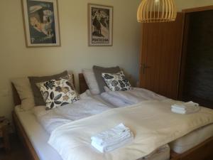 a bed with white sheets and pillows on it at Chesa Muragls in Pontresina