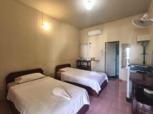 Postel nebo postele na pokoji v ubytování Pai Seview & Tewdoi ปายซีวิว ทิวดอย