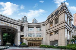 a building with a sign on the front of it at JI Hotel Shanghai Changshou Road in Shanghai
