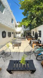 a patio with a ping pong table and chairs at The Hostal Inn in Playa del Carmen