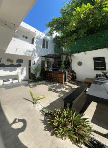 a patio of a house with a table and chairs at The Hostal Inn in Playa del Carmen