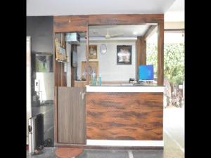 a kitchen with a counter with a wooden door at Hotel Sri Hasmitha in Vijayawāda